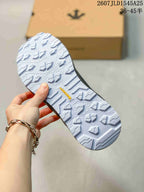 Close view of the sneaker outsole showing a light-colored patterned tread with raised traction blocks.
