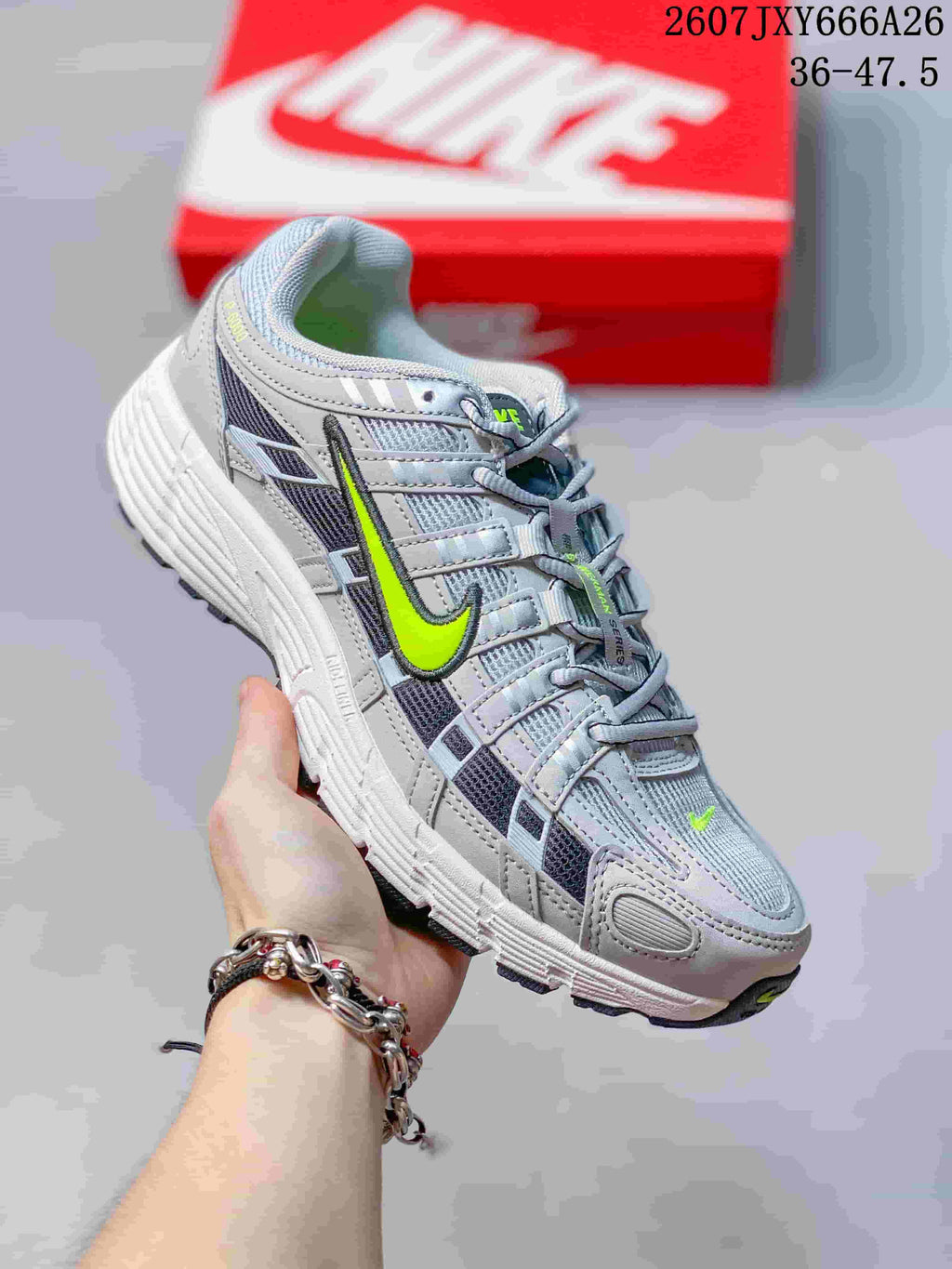 Angled side view of the grey and volt Nike P-6000 sneaker with a layered retro running-inspired upper.