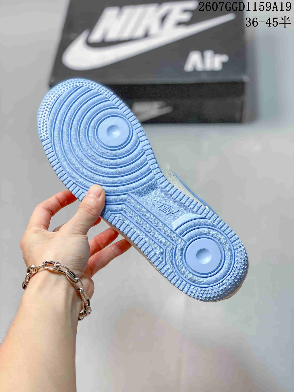 Close-up of the light blue outsole showing circular traction patterns and textured edges.