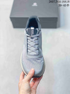 Top view of the sneaker showing the lace-up closure, padded collar, mesh-textured toe area, and protective toe overlay.
