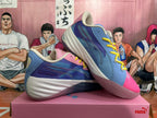 Two contrasting pink and blue basketball shoes shown together from the side and front.
