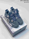 Pair of dark black and silver Air Jordan 4-style sneakers on a shoebox