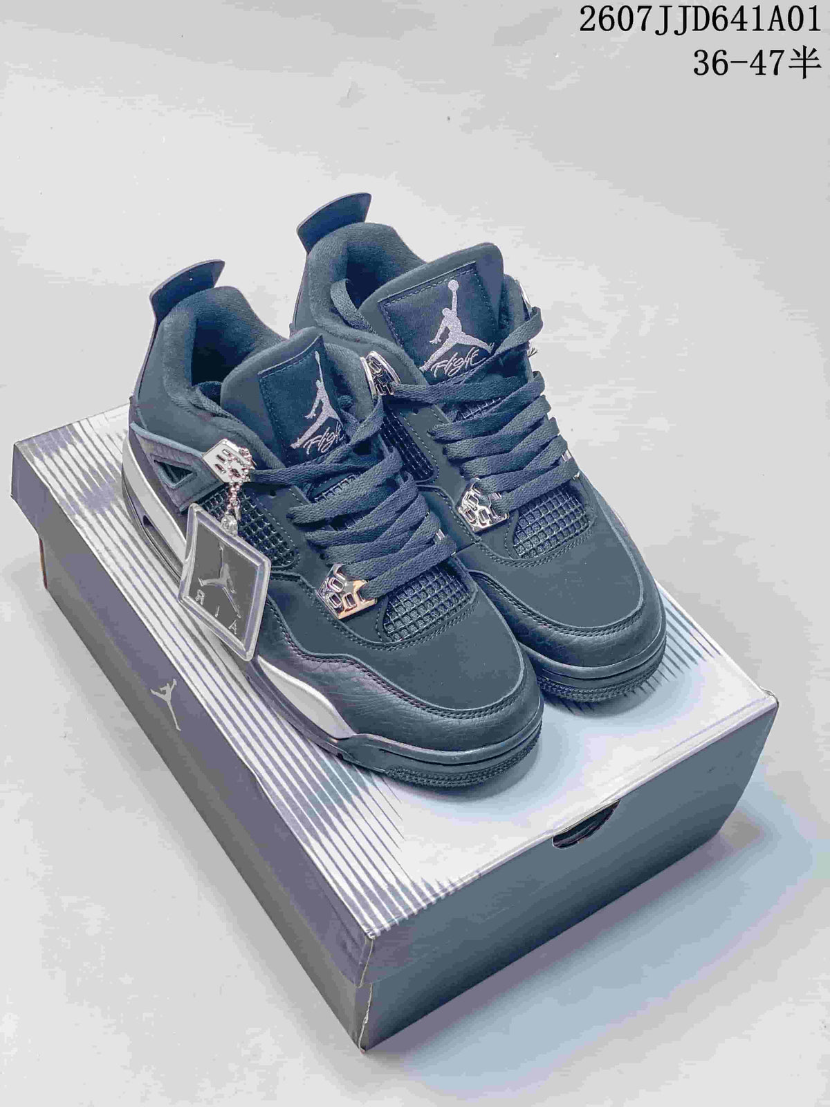 Pair of dark black and silver Air Jordan 4-style sneakers on a shoebox