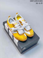 Pair of yellow JOG 2.0 sneakers with white stripes and ribbon laces
