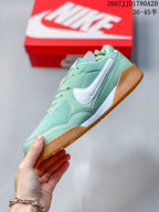 Side profile showing the mint green upper, white side branding, layered overlays and gum outsole.