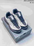 Pair of New Balance 509 sneakers in white, gray, and navy with pink accents, displayed on a shoebox.