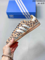 Side view showing the leopard-print upper, white three-stripe detailing, and low-profile gum outsole.
