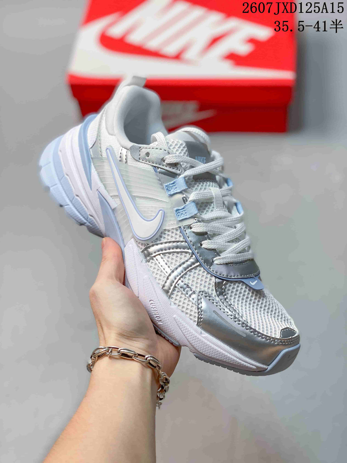 Single silver and white Nike V2K sneaker showing the mesh upper, layered side detailing, laces, and outsole.