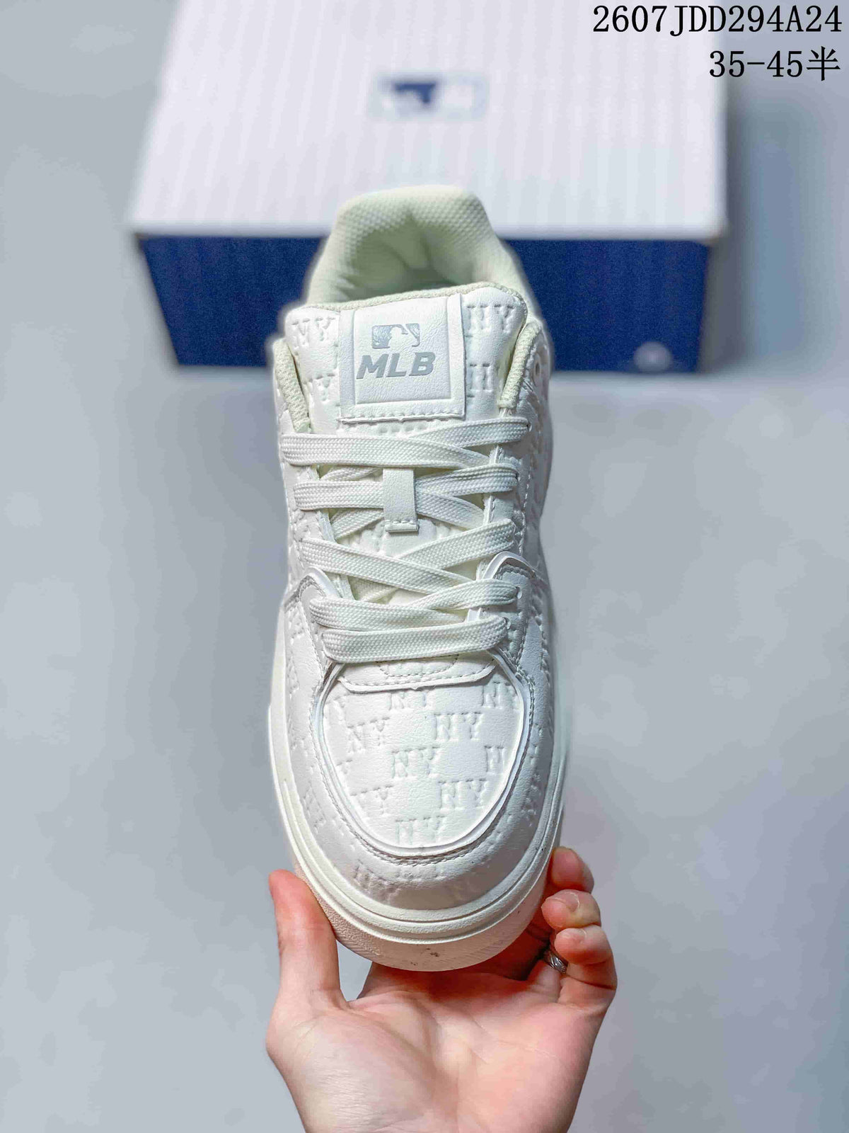 Top view of the white sneaker showing the lace-up construction, padded tongue, embossed toe box and MLB tongue label.
