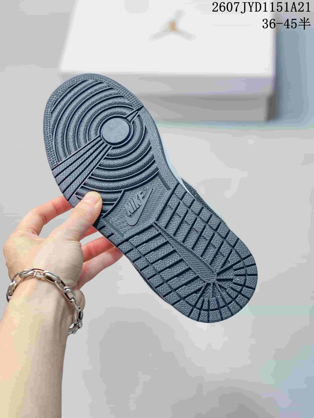 Underside view showing the black patterned rubber outsole with concentric traction rings and Jordan branding.