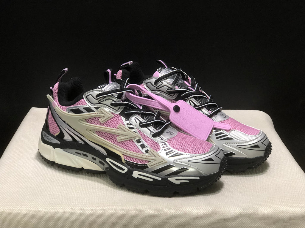 Three-quarter front view showing the pair of pink, black, and white lace-up sneakers and attached pink tag.