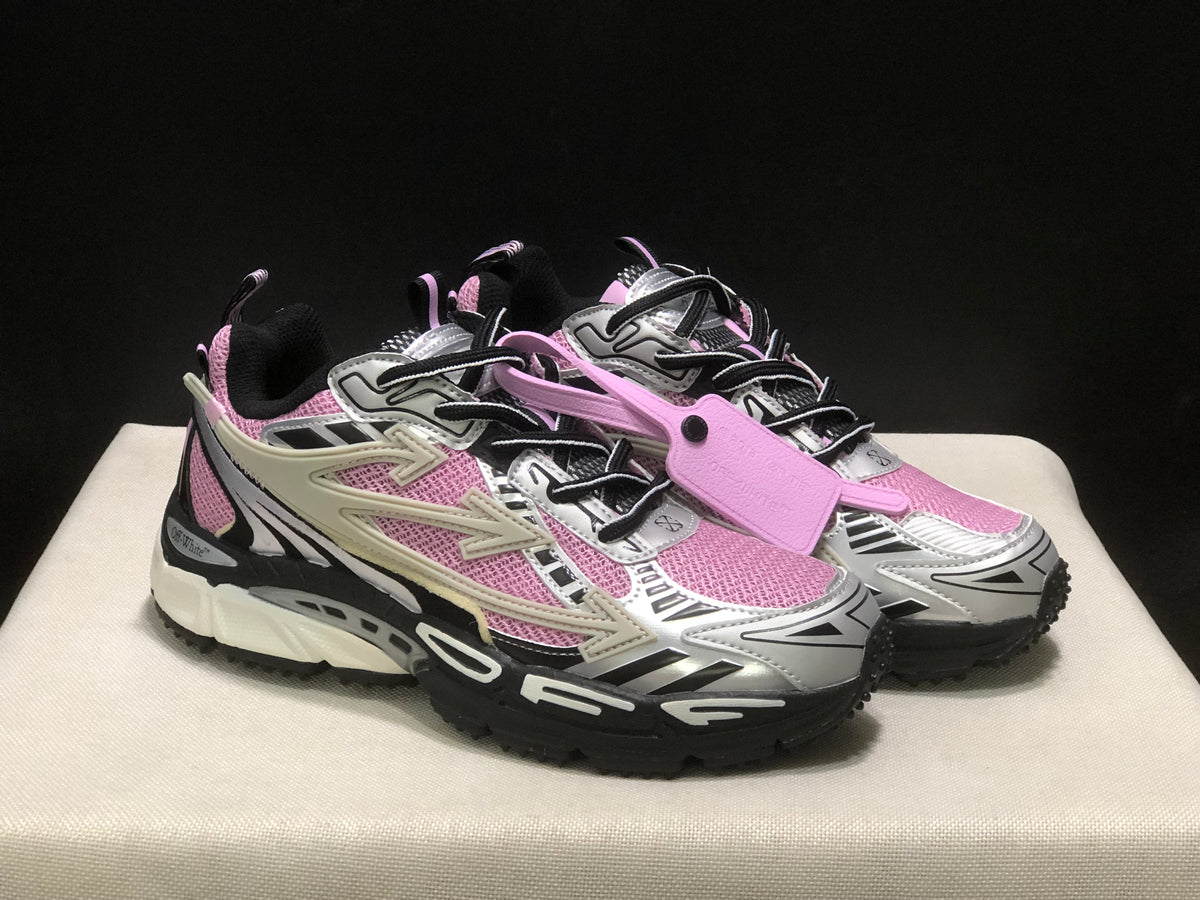 Three-quarter front view showing the pair of pink, black, and white lace-up sneakers and attached pink tag.