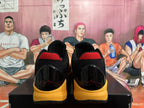 Rear view of yellow and black Nike basketball shoes with red heel accents