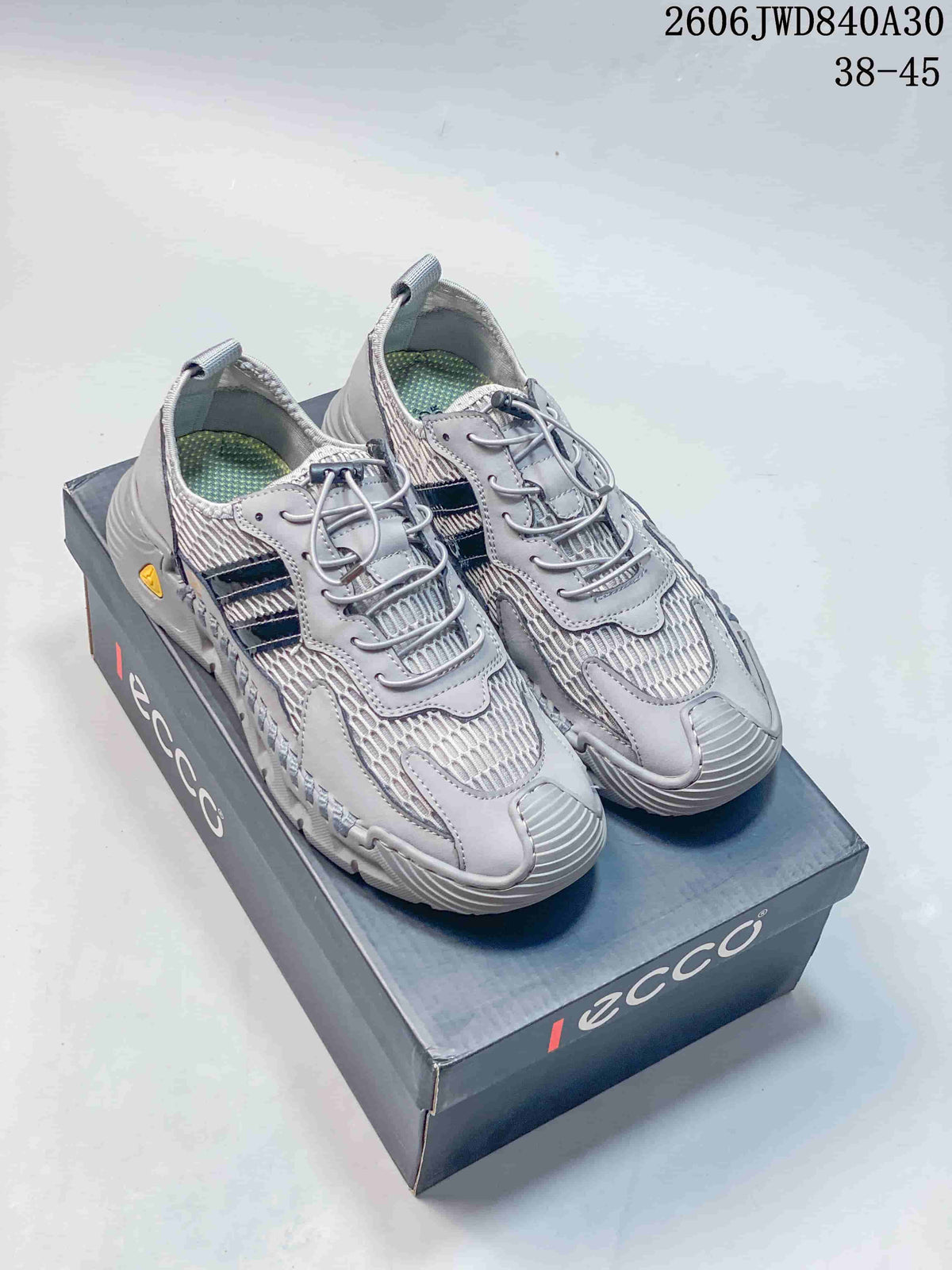 Pair of gray ECCO mesh sneakers shown on a branded shoe box