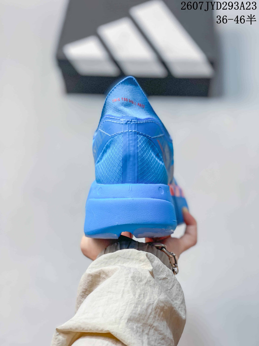 Rear view of the blue sneaker showing the heel construction, blue upper and red interior lining.