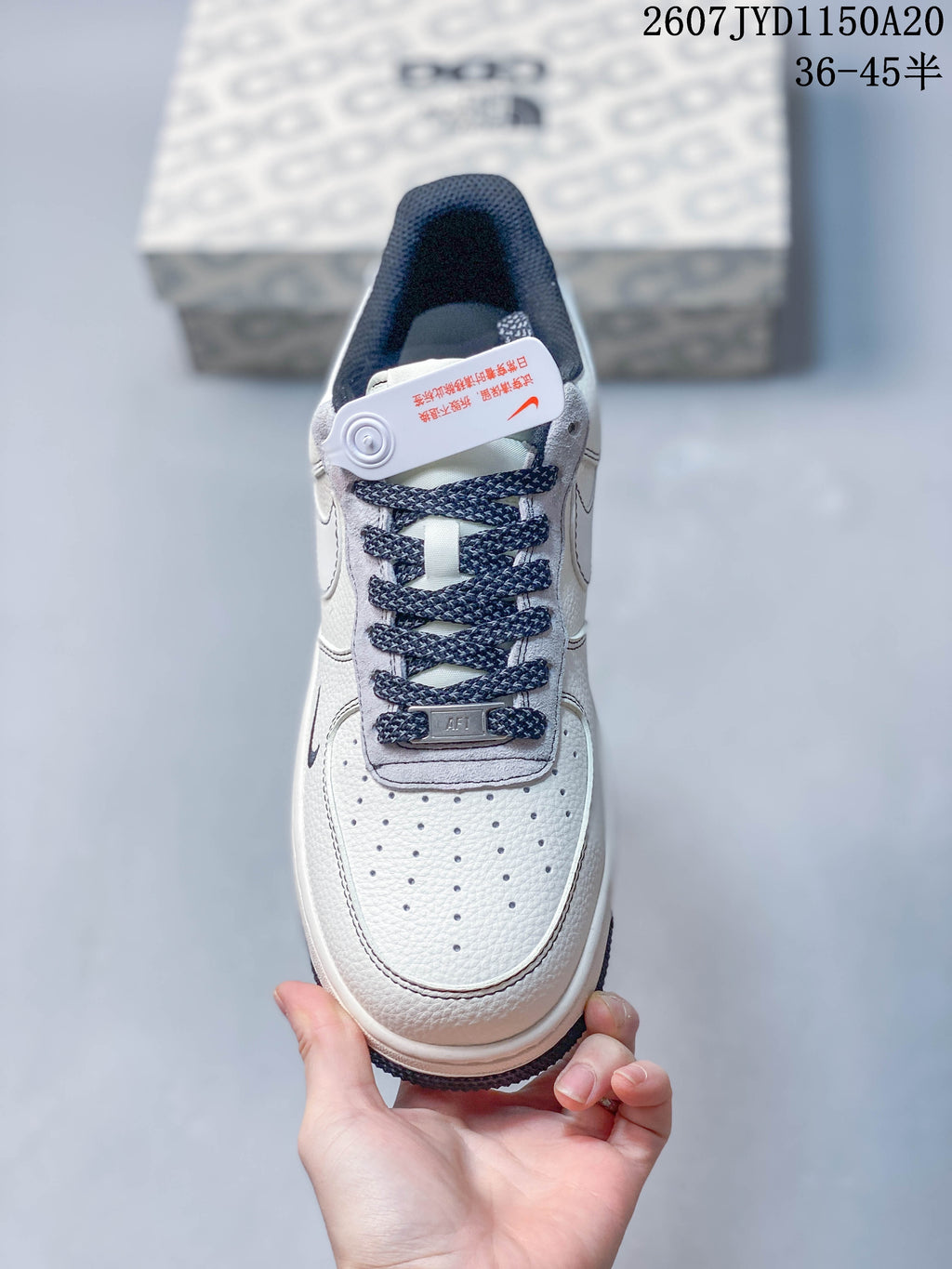Top view of the sneaker showing the perforated toe box, navy laces, gray tongue trim and AF1 lace tag.