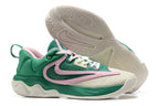 Green and cream basketball shoe with pink accents