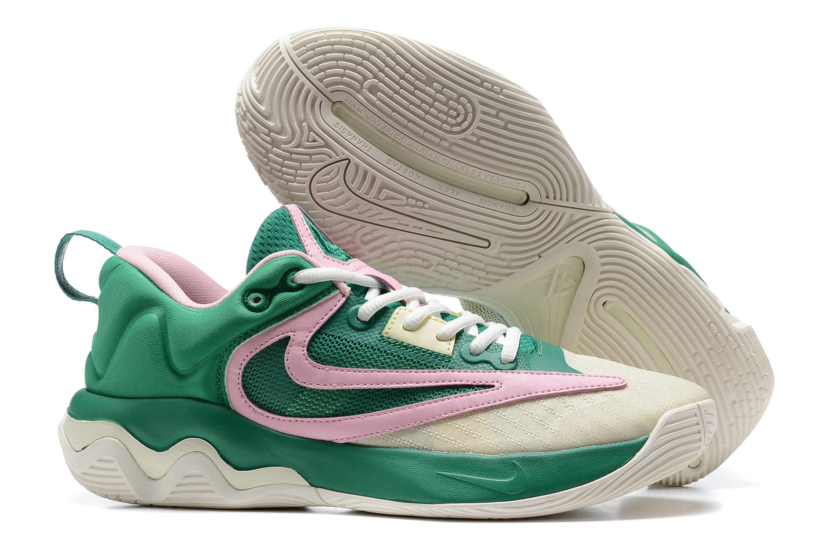 Green and cream basketball shoe with pink accents