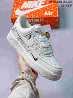 Angled view of a cream-white Air Force 1 sneaker with patterned side panels and contrasting Swoosh details