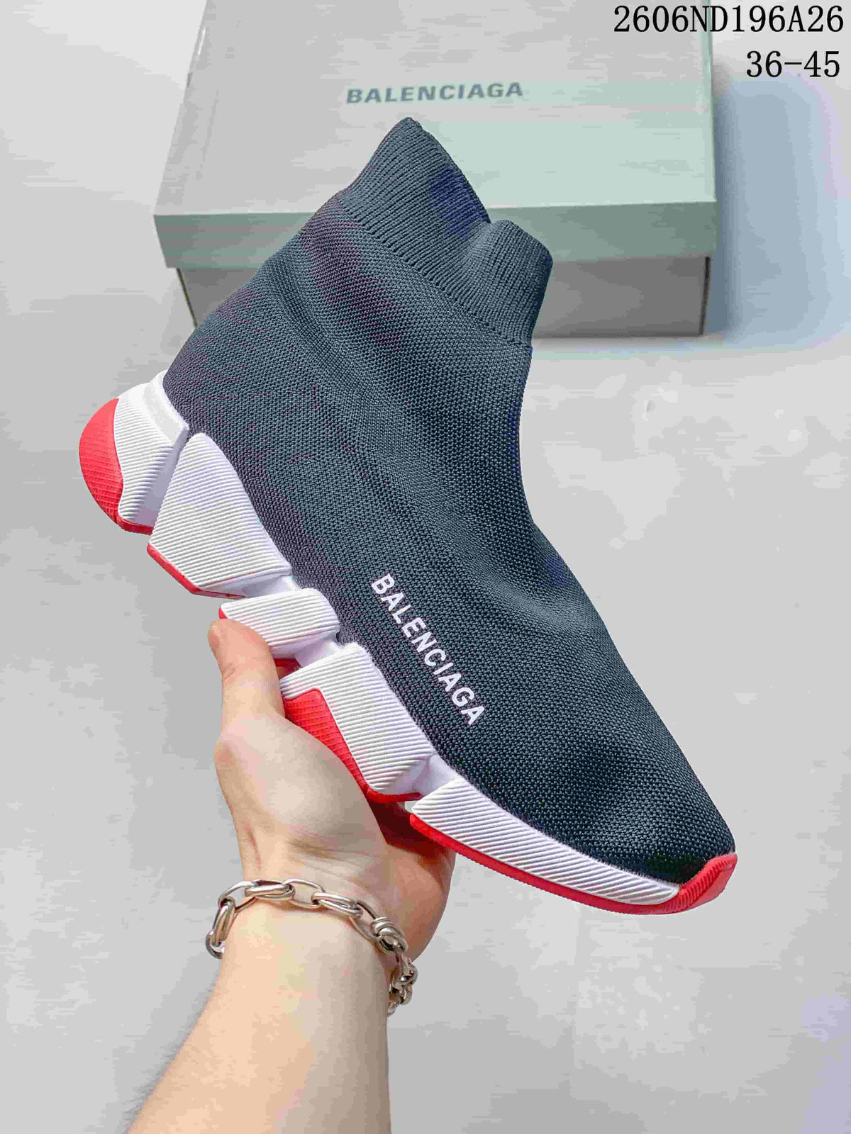 Dark knit sock-style sneaker with a white segmented sole and red accents.