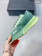 Side view of the green patterned sneaker showing the lace area, layered upper design, pale lime midsole, and textured outsole.