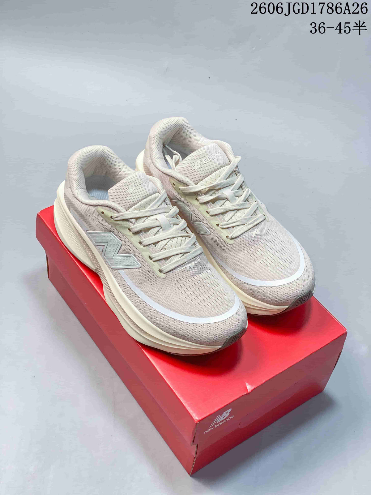 Pair of light neutral New Balance Ellipse V1 running shoes displayed on a red shoe box