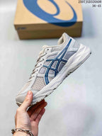 Side profile highlighting the gray mesh upper, blue ASICS detailing and white midsole.