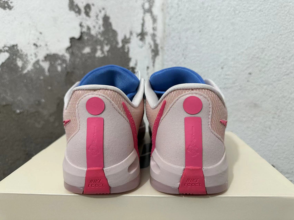 Rear view of blue and pink Nike Kobe basketball shoes showing pale heel panels and pink heel details