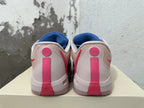 Rear view of blue and pink Nike Kobe basketball shoes showing pale heel panels and pink heel details