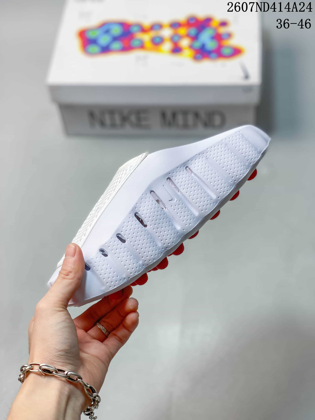 Side view of the white slide showing perforated sidewalls, a sculpted sole profile and red outsole details.