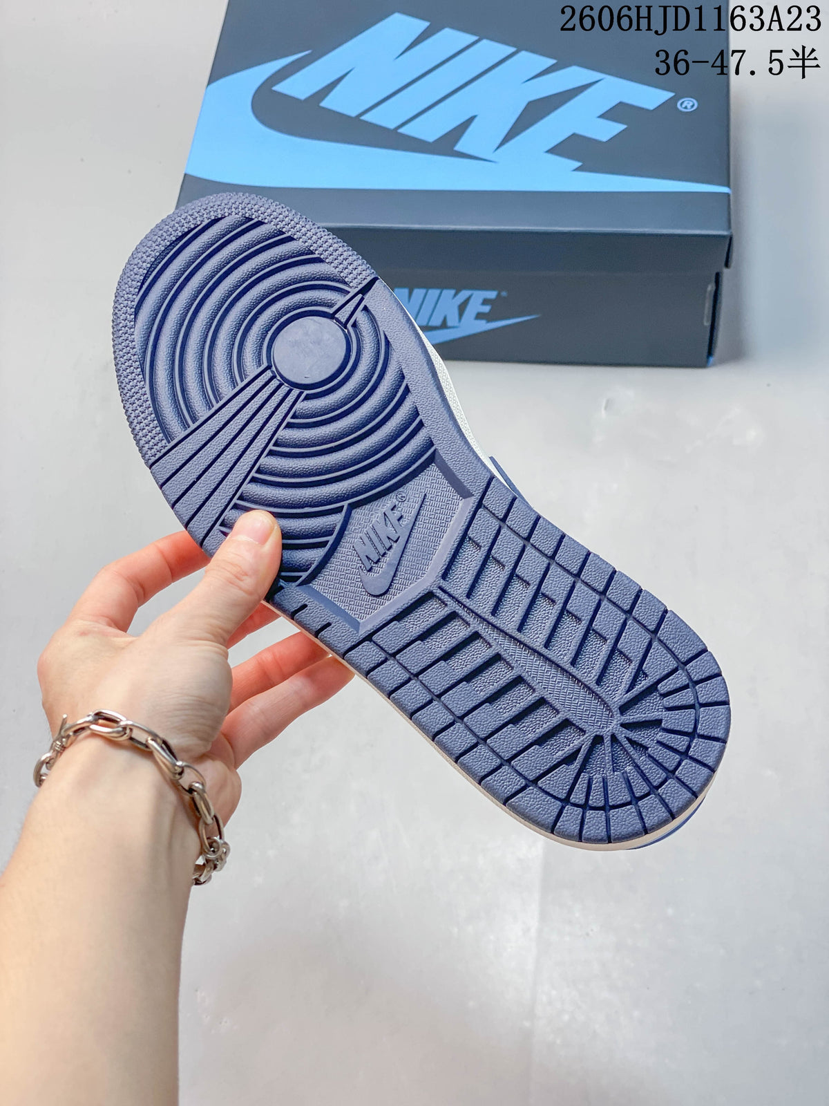 Close-up of the blue patterned outsole on a Jordan Air Jordan 1 Low sneaker