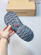 Close view of the Salomon XA PRO 3D outsole showing a deep, directional lug pattern and a red outsole detail.