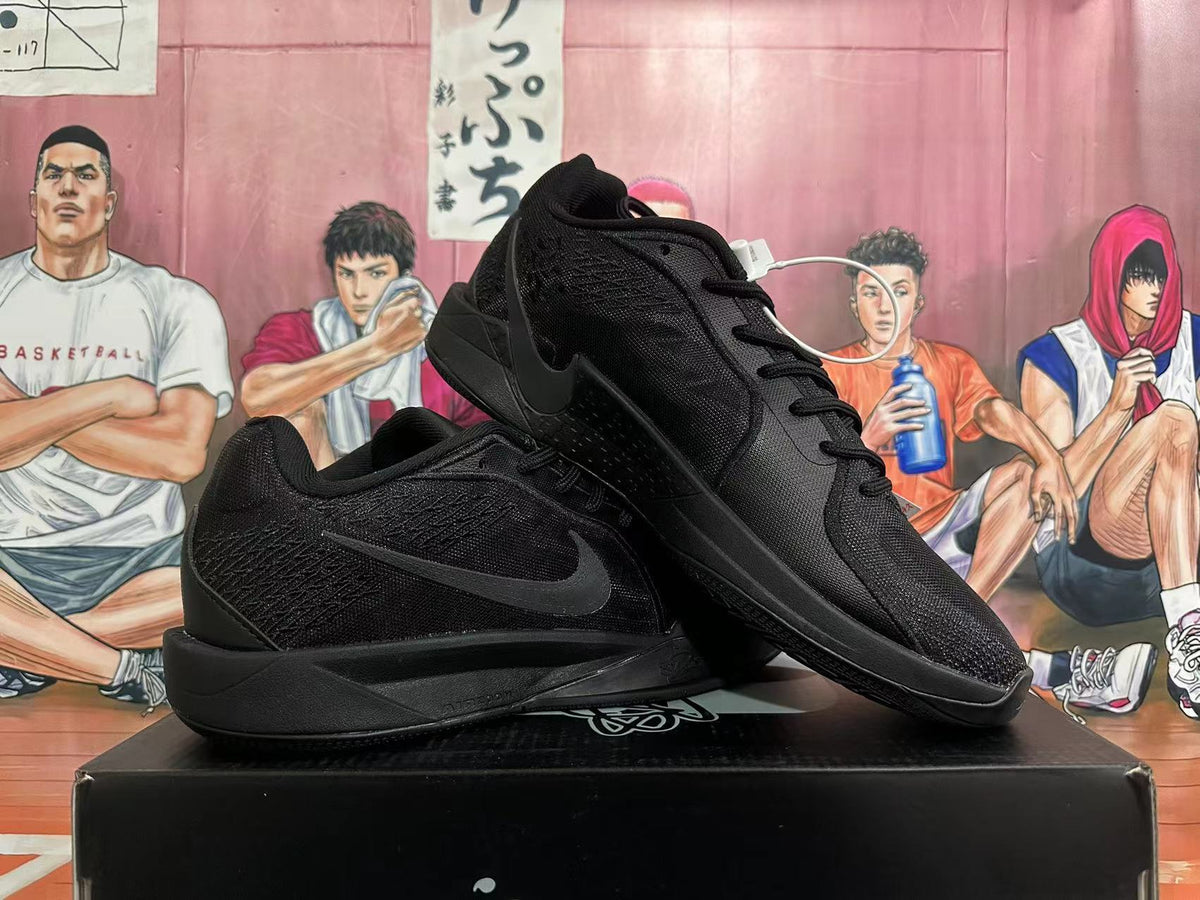 Two black Nike basketball shoes arranged to show their side profiles