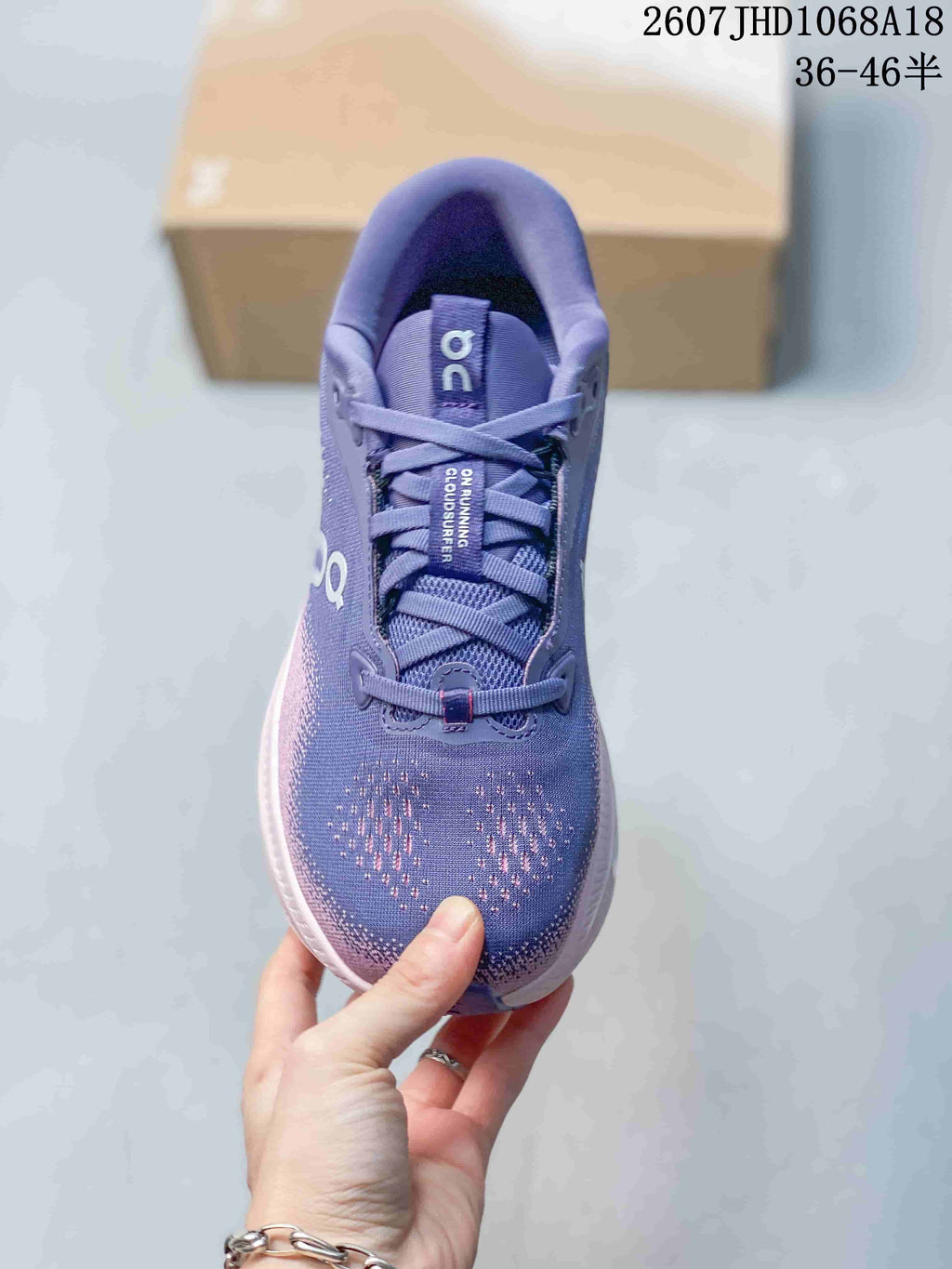 Top-down view showing the purple lace-up upper, padded tongue, patterned toe box, and side branding.