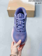 Top-down view showing the purple lace-up upper, padded tongue, patterned toe box, and side branding.