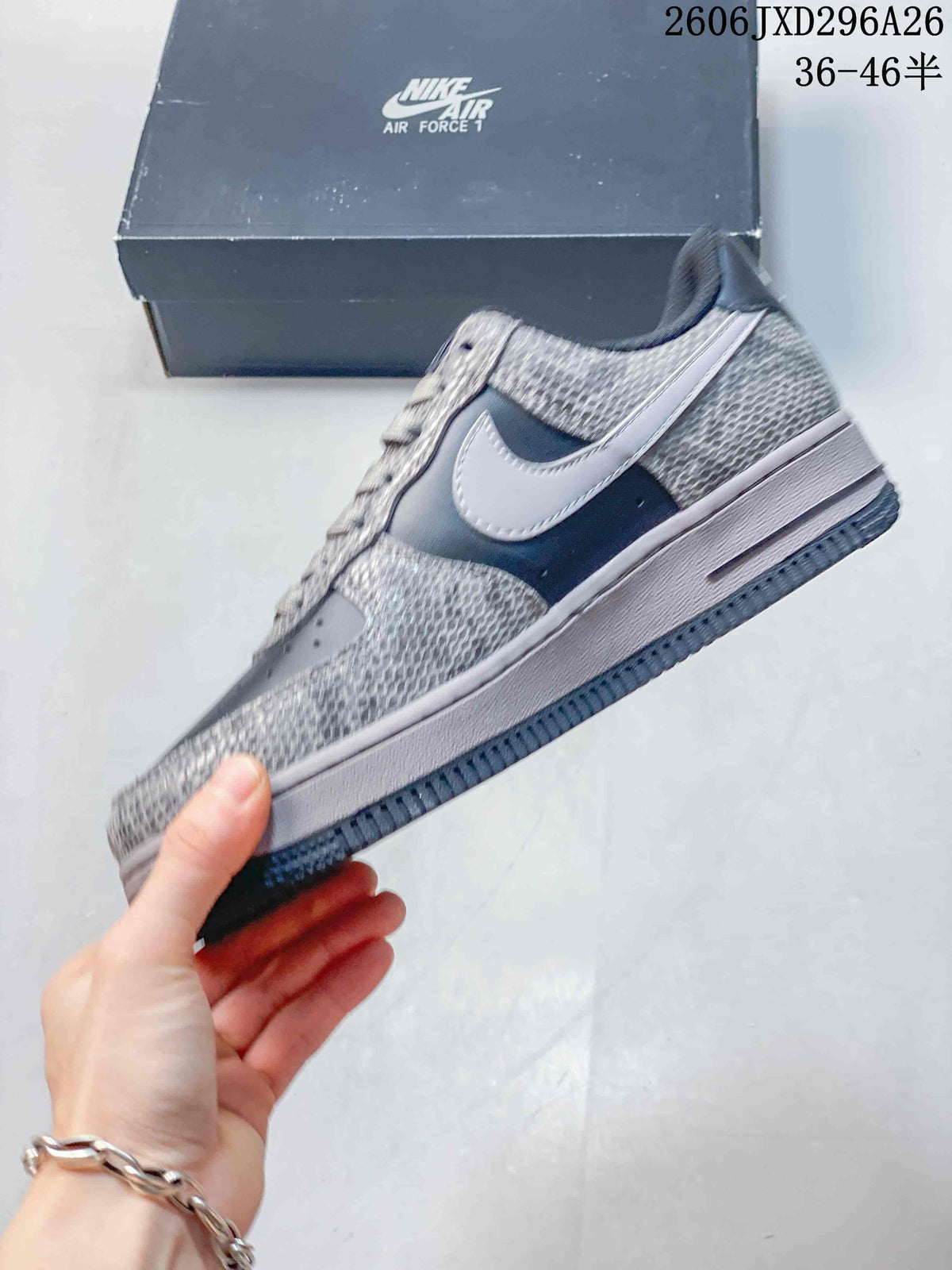 Side view highlighting the contrasting Swoosh, patterned panels, midsole, and dark outsole.