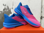 Pair of pink and blue Nike Precision 7 basketball shoes