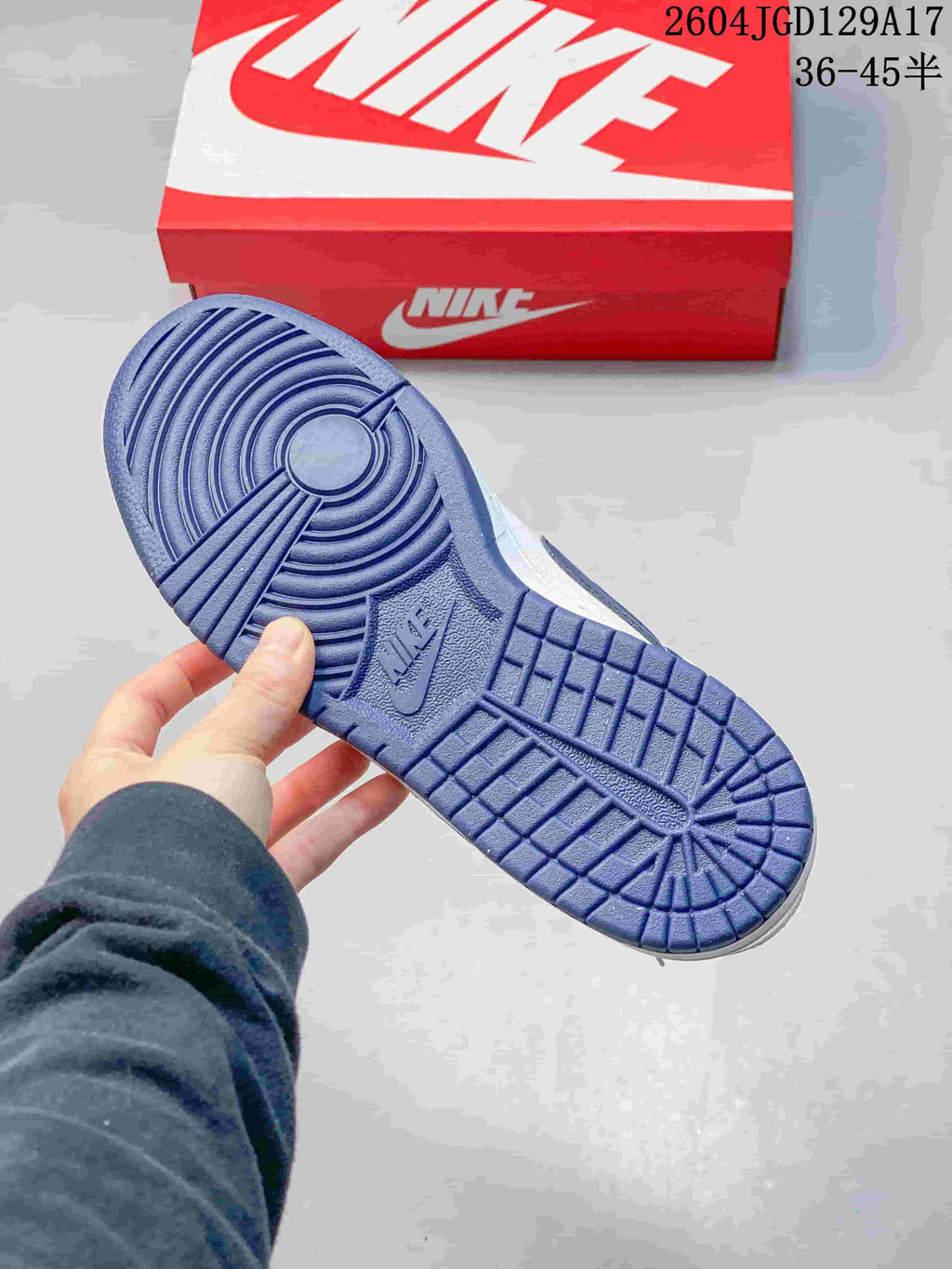 Blue outsole showing the circular and block-pattern tread