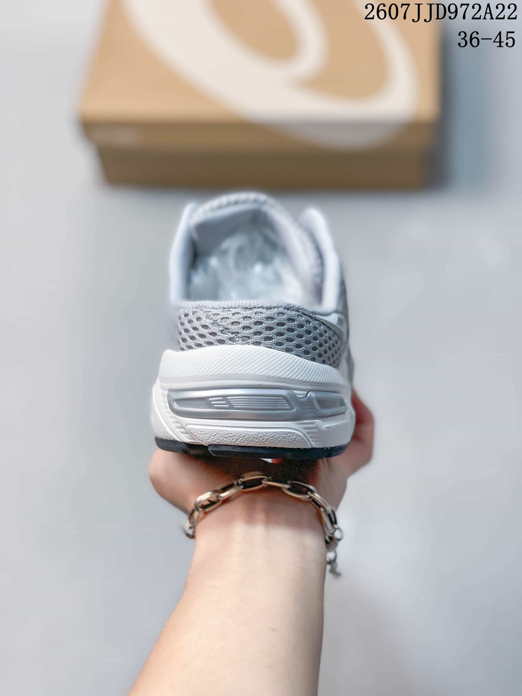 Rear view showing the padded heel collar, layered heel structure and outsole of the sneaker.