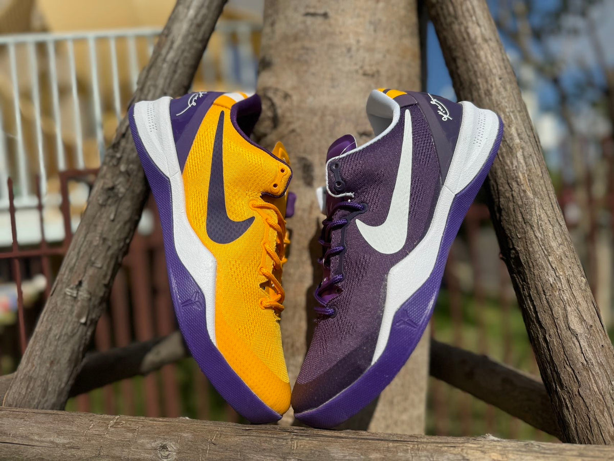 Gold and purple Kobe 8 shoes displayed side by side