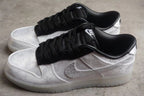 Pair of white and black low-top sneakers shown from an angled side view.