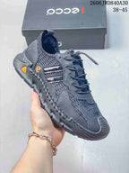 Side view of a dark gray ECCO mesh sneaker with textured overlays and a treaded outsole