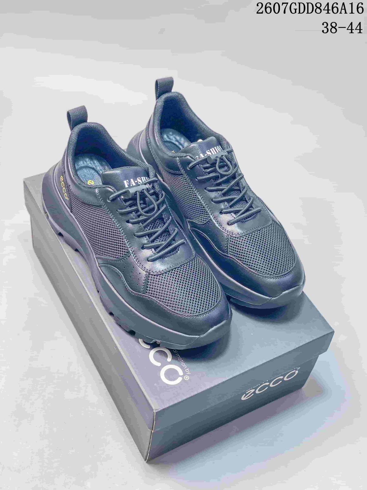 Black ECCO lace-up sneakers displayed on a branded shoe box, with mesh panels, contrasting overlays and a lugged outsole.