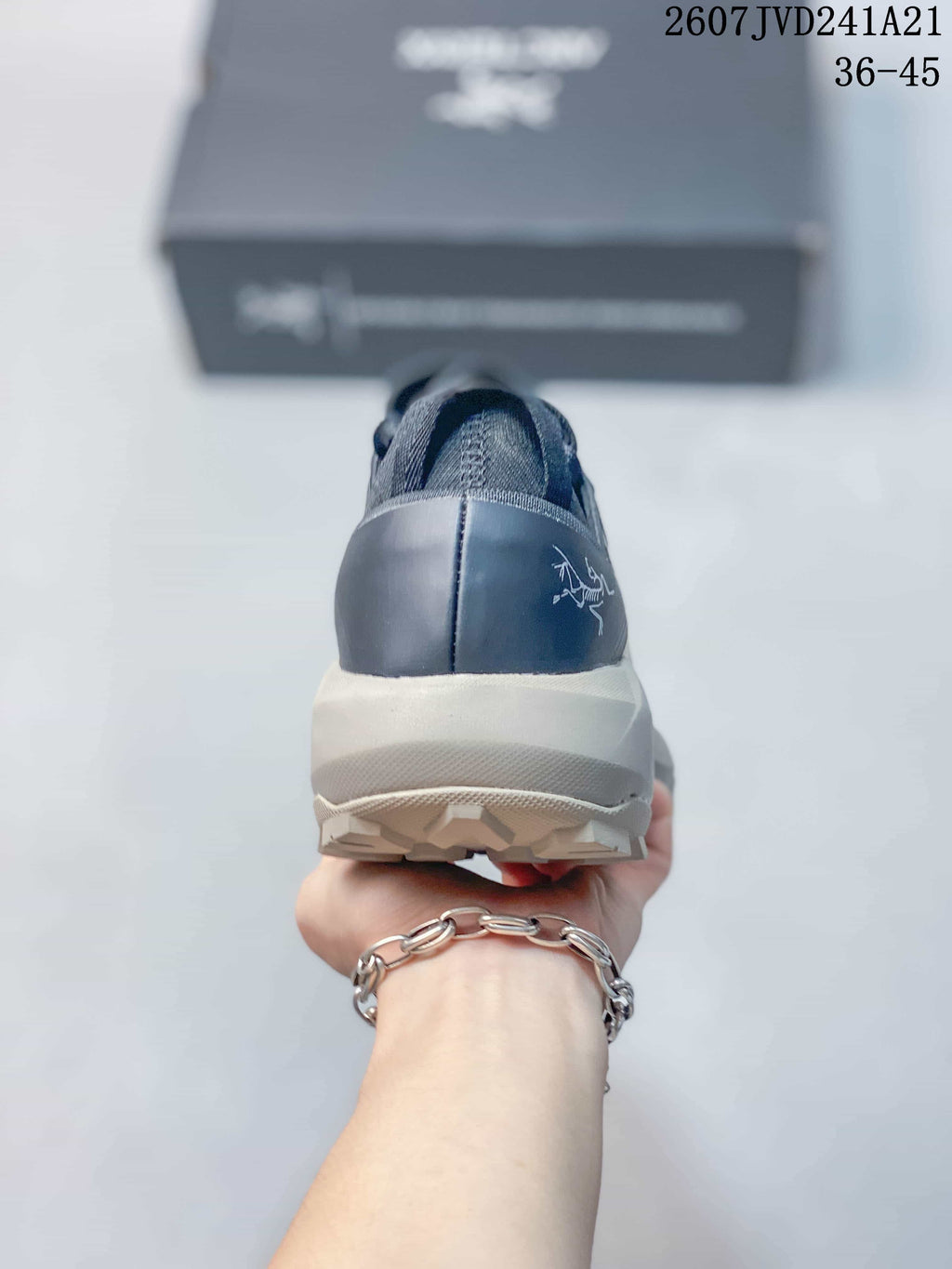 Rear view showing the structured heel, dark heel counter, light midsole, and outsole lugs.