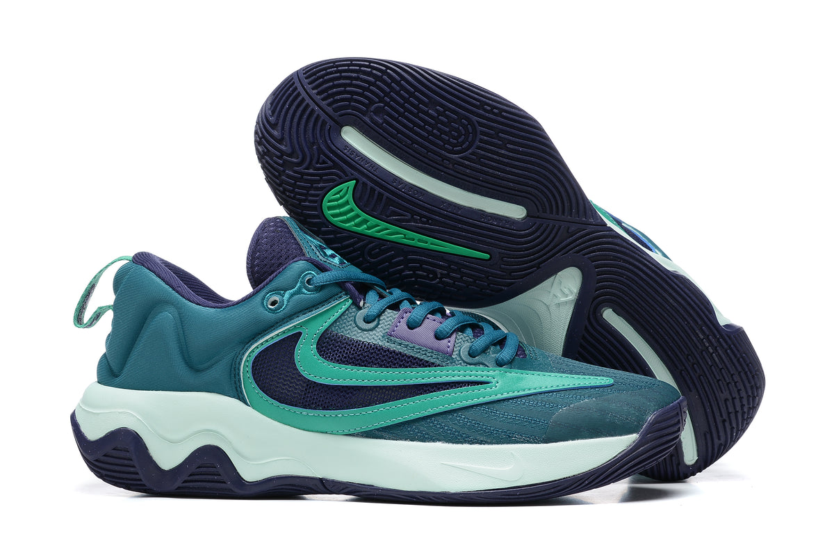 Teal and navy basketball shoe with mint-colored sole accents
