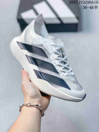 Side view of the white Adidas Adizero Adios Pro Evo 2 shoe with dark blue and black layered panels.