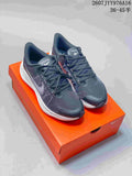 Pair of black and white Nike Zoom Winflo 8 sneakers displayed on an orange shoe box.
