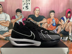 Side view of black Nike basketball shoe with a white Swoosh and white midsole