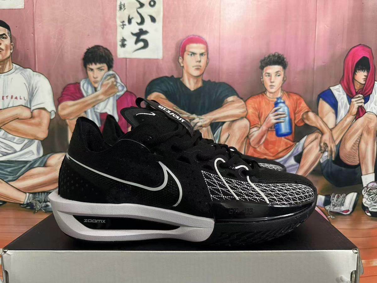 Side view of black Nike basketball shoe with a white Swoosh and white midsole