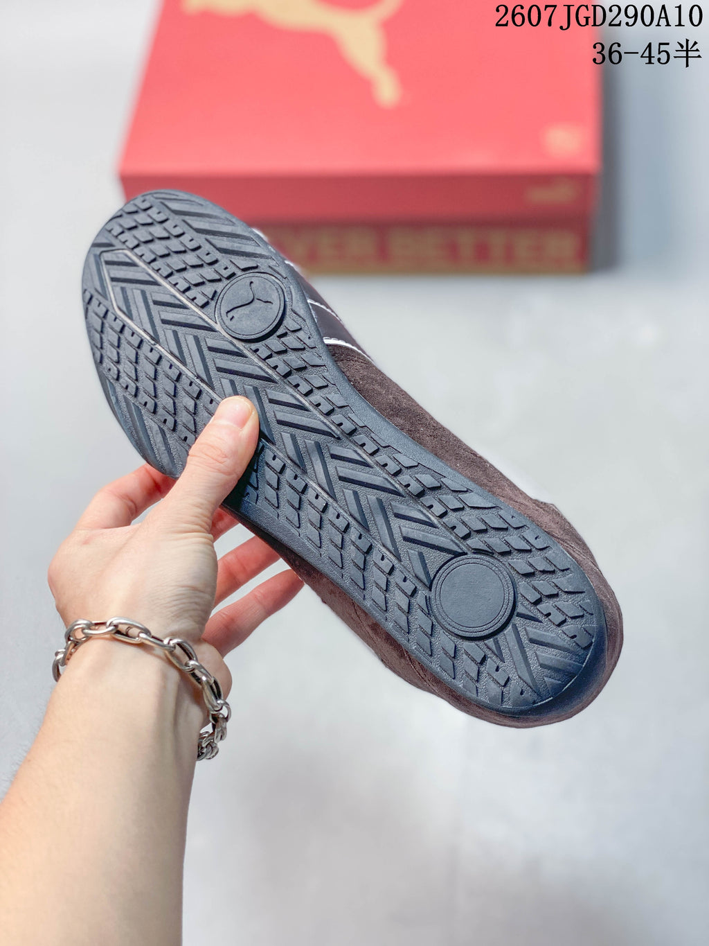 Close view of the sneaker outsole showing a dark rubber sole with a patterned tread and circular pivot details.